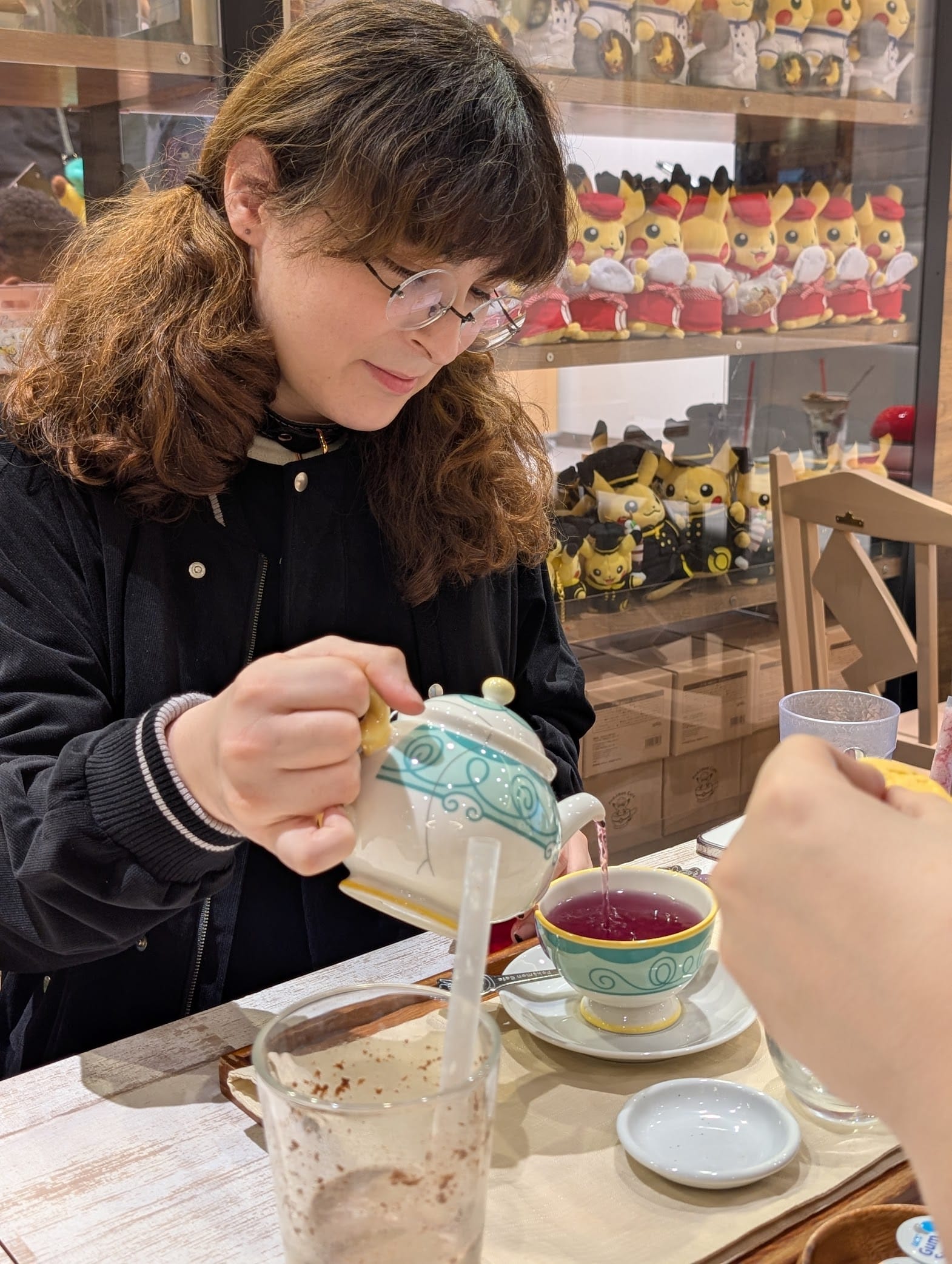 Lily pouring a cup of tea