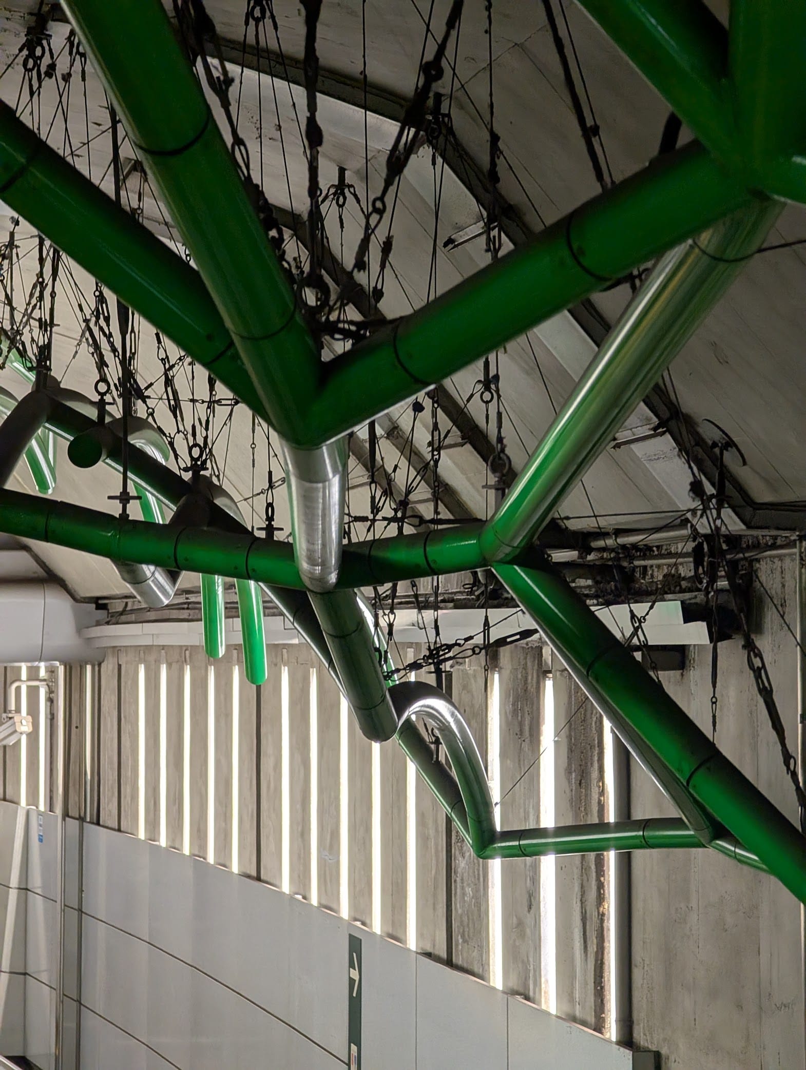 A web of green tubes reflecting light from behind
