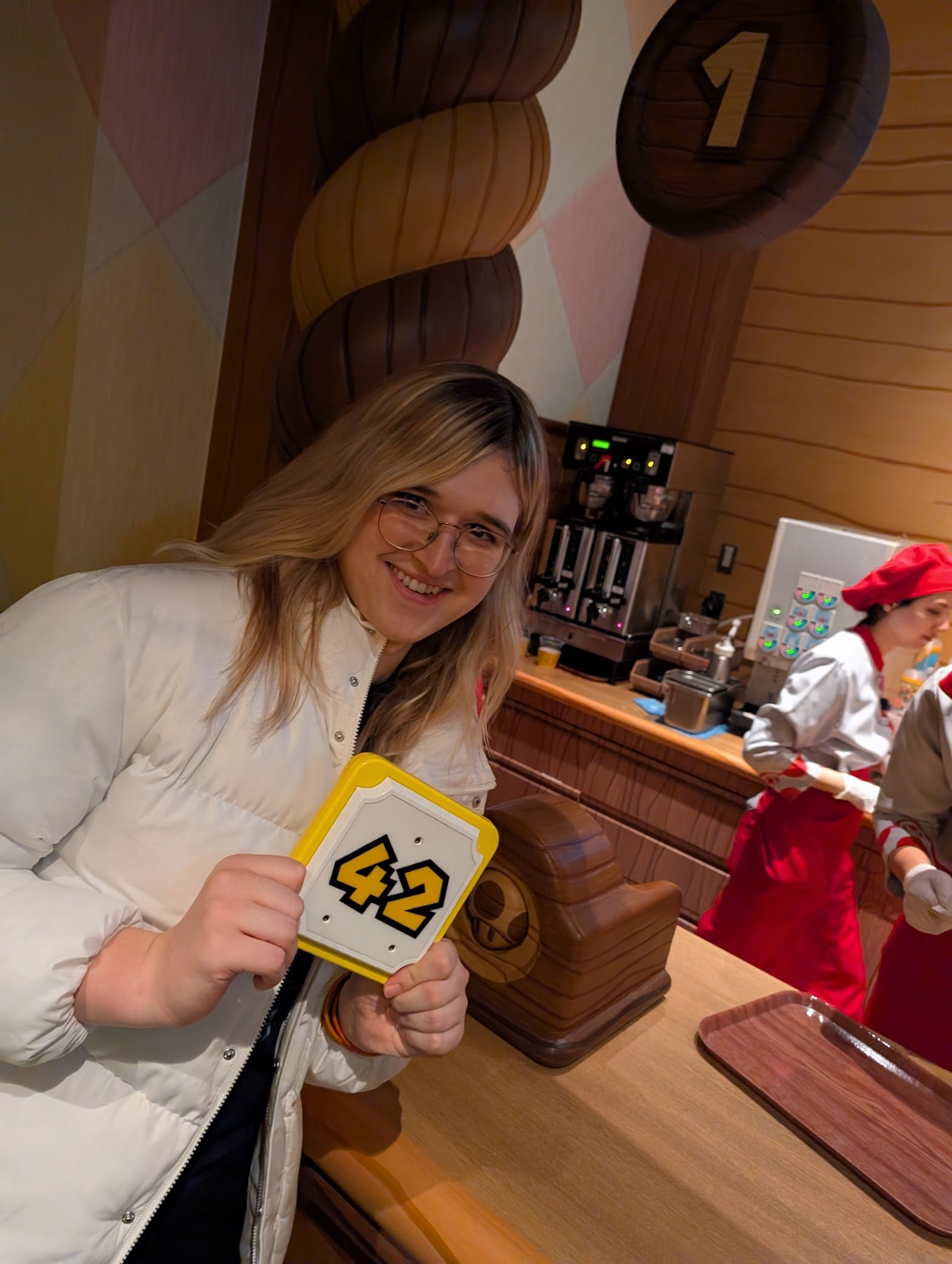 Vivi posing with our table number themed like a mario block